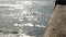 Railings of wooden pier, waterfront boardwalk, California beach USA. Defocused ocean, sea waves.