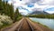 Railroad along the river next to a mountain