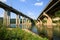 Railroad and automobile trestle bridges over Tsonevo dam, at Luda Kamchia river in Bulgaria against blue sky with clouds. Transpor