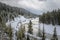 Railroad on a the Bank of a Frozen River in a Mountain Landscape