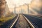 Railroad in beautiful forest in fog at sunrise in autumn