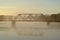 A railroad bridge over a foggy and misty river early mo