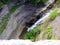 Railroad bridge overlooks gorge ravine and waterfall