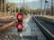 A railroad color position light sits ground level flashing red s