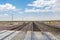 Railroad crossing gates on a road in the Mojave Desert