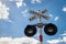 Railroad Crossing Sign with blue clear sky and white clouds. Railway crossing sign with flashing lights