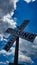 Railroad Crossing sign with vivid clouds in background on a pole