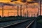 Railroad infrastructure during beautiful sunset and colorful sky, railcar and traffic lights, transportation and industrial concep