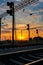 Railroad infrastructure during beautiful sunset and colorful sky, railcar and traffic lights, transportation and industrial concep