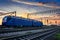 Railroad infrastructure during beautiful sunset and colorful sky, trains and wagons, transportation and industrial concept