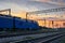 Railroad infrastructure during beautiful sunset and colorful sky, trains and wagons, transportation and industrial concept