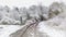 Railroad leading through snowy and foggy landscape