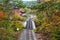 Railroad line running over a small bridge and through colourful autumnal trees