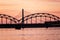 railroad metal bridge silhouette over river of Daugava in Riga,