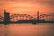 railroad metal bridge silhouette over river of Daugava in Riga,