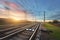 Railroad in motion at sunset. Railway station