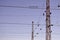 Railroad overhead lines against clear blue sky, Contact wire. High voltage railroad power lines on neutral blue sky backgroun