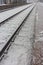 Railroad perspective along snow platform station in winter. Travel and journey background. Transport concept.