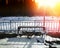 Railroad station bench with dramatic light leak background