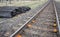 Railroad ties lying beside railroad tracks.