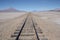 Railroad to nowhere in a stone desert