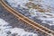 Railroad track on a rocky and snowy ground