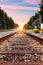 Railroad tracks against beautiful sky at sunset