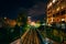 Railroad tracks and buildings at night, in Uptown Charlotte, Nor