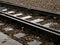 Railroad tracks in heavy rain, water reflections abstract. Wet train tracks, water on railway closeup, detail. Sad, melanholic