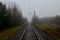 Railroad tracks in a misty haze after rain in the autumn