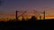 Railroad tracks, overhead lines, silhouette with trees, in  sunset