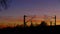 Railroad tracks, overhead lines, silhouette with trees, in  sunset