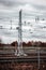 Railroad tracks and power line behind wired fence