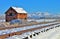 Railroad tracks and red barn