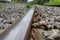 Railroad tracks and rocks in Thailand, metal railway of train.