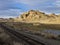 Railroad tracks running past a desert ranch