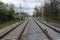 Railroad tracks for trains  with steel rails and gravel creating straight perspective lines till horizon