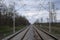 Railroad tracks for trains  with steel rails and gravel creating straight perspective lines till horizon