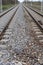 Railroad tracks for trains  with steel rails and gravel creating straight perspective lines till horizon