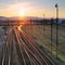 Railroad with train at sunset and many lines