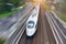 Railroad travel high speed fast train passenger locomotive motion blur effect in the city, top aerial view from above
