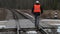 Railroad worker with documentation and adjustable wrench cross railway crossing