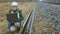 Railroad worker with laptop PC near rails