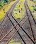 Railroads crossing on gravel in sunlight