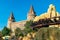 Rails and fairy castle in the amusement park under the evening sun