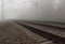 Rails on the railway, leaving into the foggy distance