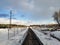 rails in the snow. railway track enclosed by a barbed wire fence