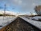 rails in the snow. railway track enclosed by a barbed wire fence