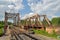 Railway bridge across the river and the rails with the arrow in