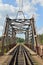 Railway bridge across the river and the rails with the arrow in